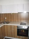 Кухненски шкафове бял гланц и дървесен декор
